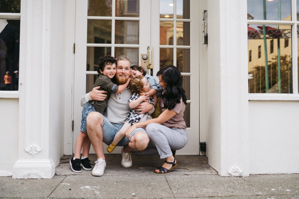 fun loving family of five hanging out together in the city.