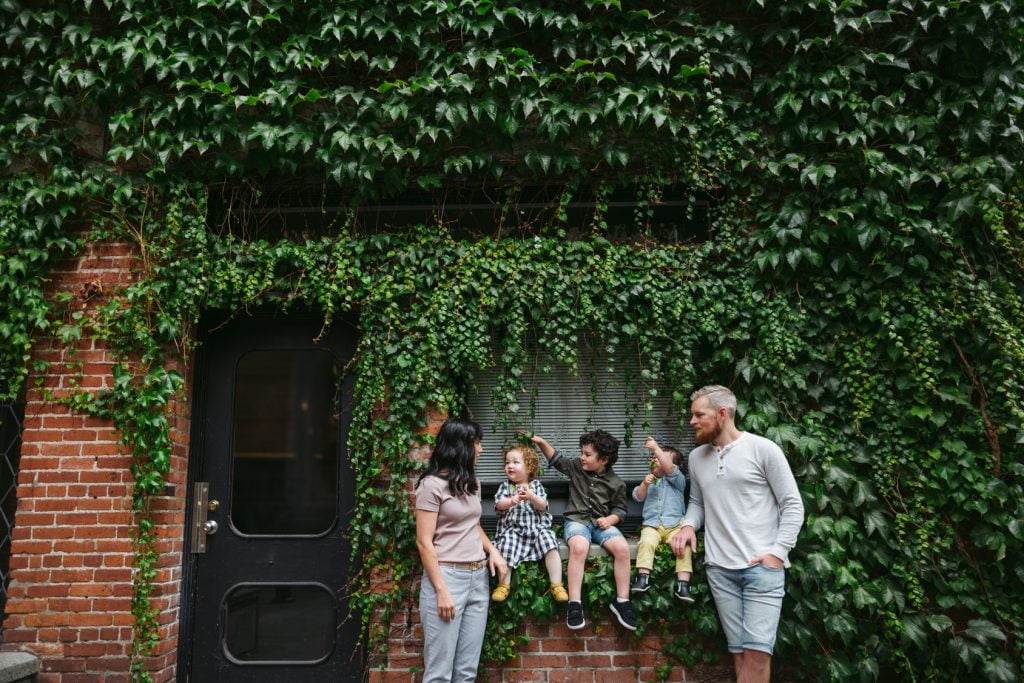 fun loving family of five hanging out together in the city.