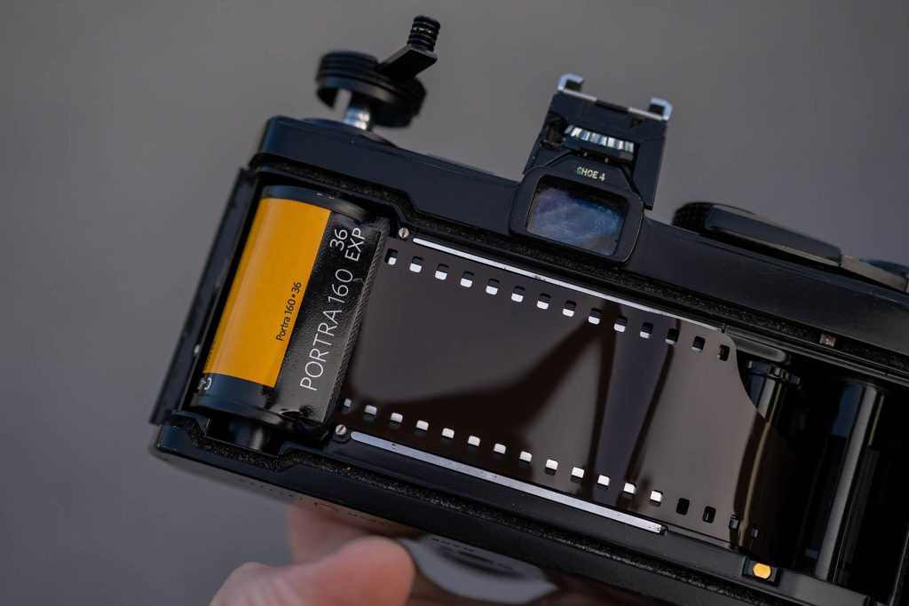 analog slr camera being loaded with kodak portra 160 colour film