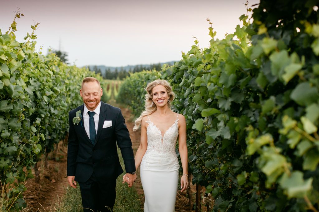happy couple walking together in vineyard