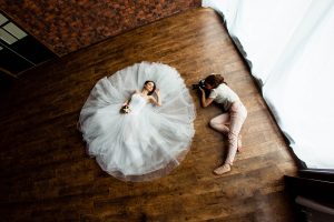 young sexy woman photographer is taking pictures the bride in th