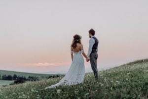 beautiful bride and groom at sunset in green nature.